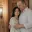 A couple standing close together indoors.