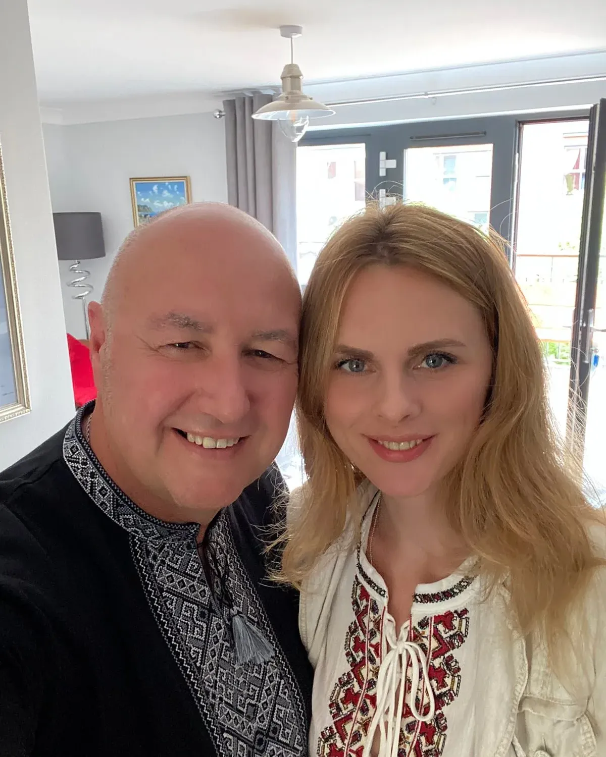 Gary and Elena smiling together indoors.